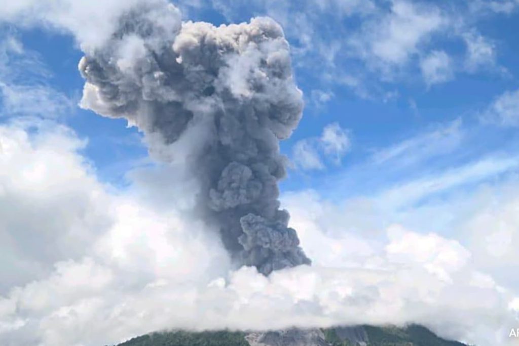 Mount Ibu in Indonesia erupts, releasing thick ash and dark clouds into the sky.