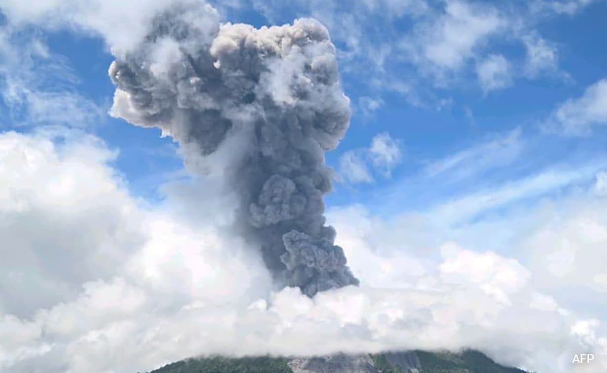 Mount Ibu in Indonesia erupts, releasing thick ash and dark clouds into the sky.